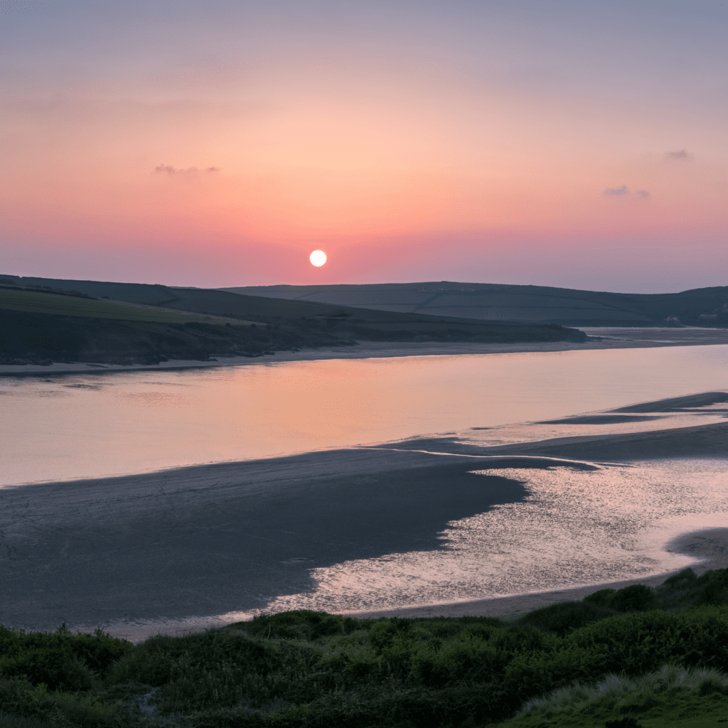 camel estuary during sunrise with pink skies and empty sand banks