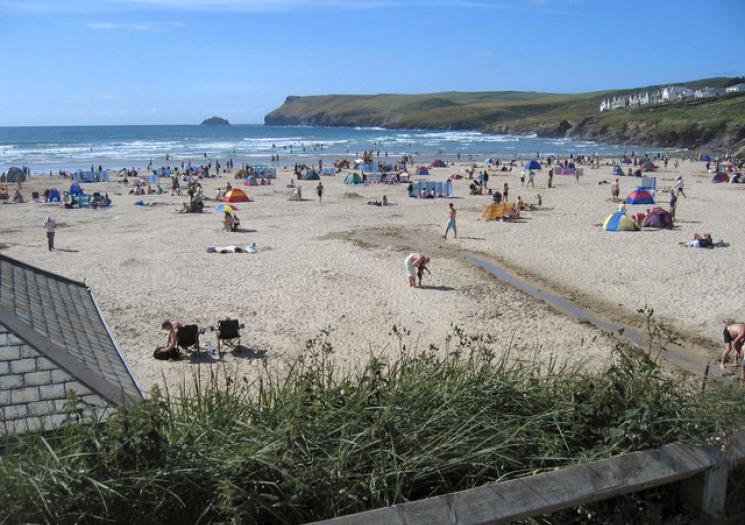 Polzeath Beach in summer with lots of people and tents