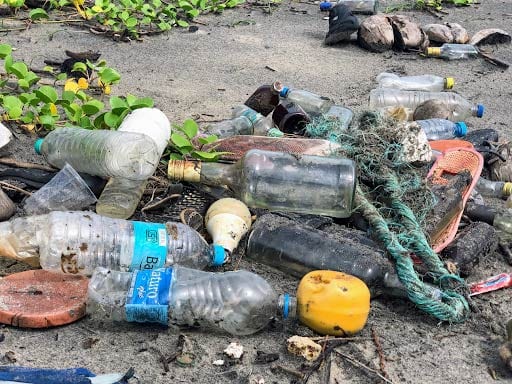 photo of rubbish scattered on beach