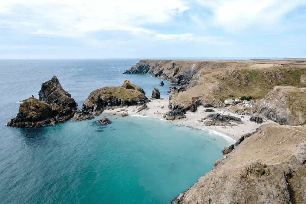 cornwall hidden gem with clear water and a sand beach surrounded by cliffs