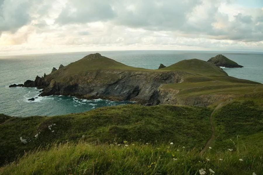 green trails of cornish coast with the sea in the background