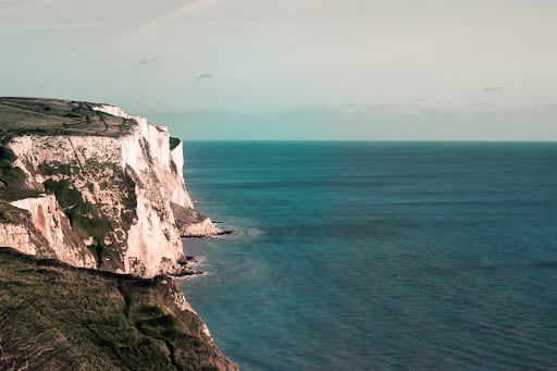 photo of white cliffs overlooking a blue green sea